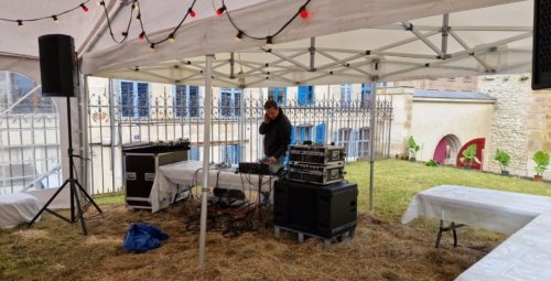 Nicolas en train de tester le matériel son de la guinguette abrité par le barnum de 15 mètres dans le jardin du collège